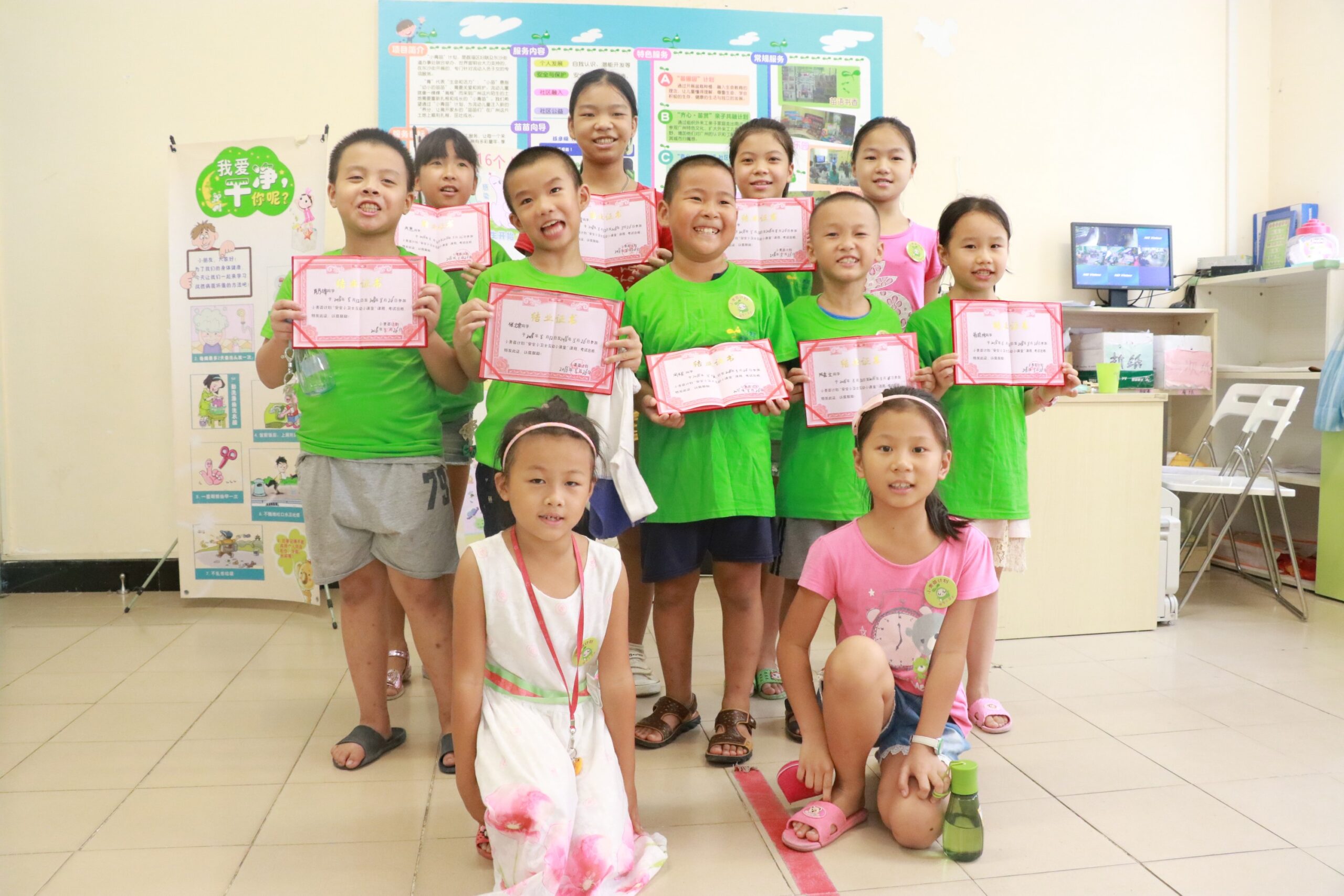 Graduation photo of migrant students who completed in the "Little Safety Guard" course, implemented by World Vision and funded by HKS Education Fund. The course taught them about living in a clean and safe community environment.